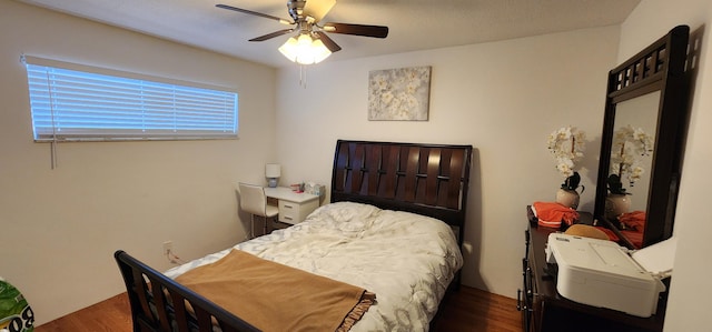 bedroom with ceiling fan and dark hardwood / wood-style flooring