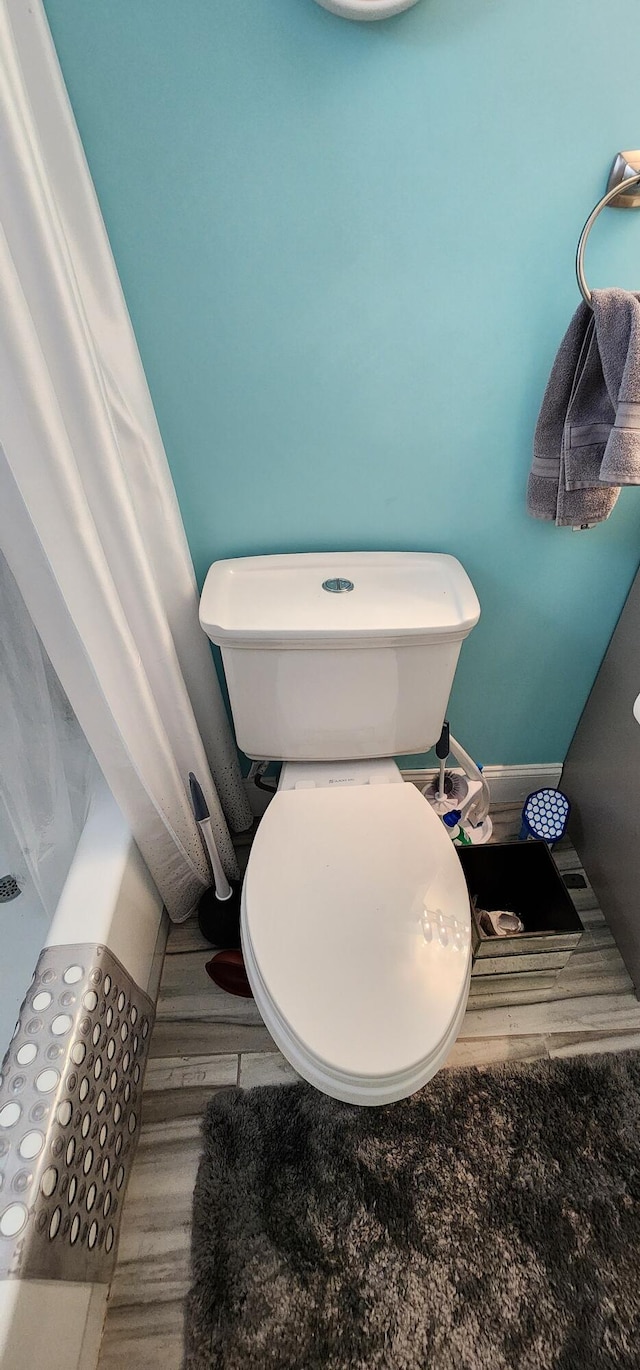 bathroom with hardwood / wood-style floors and toilet