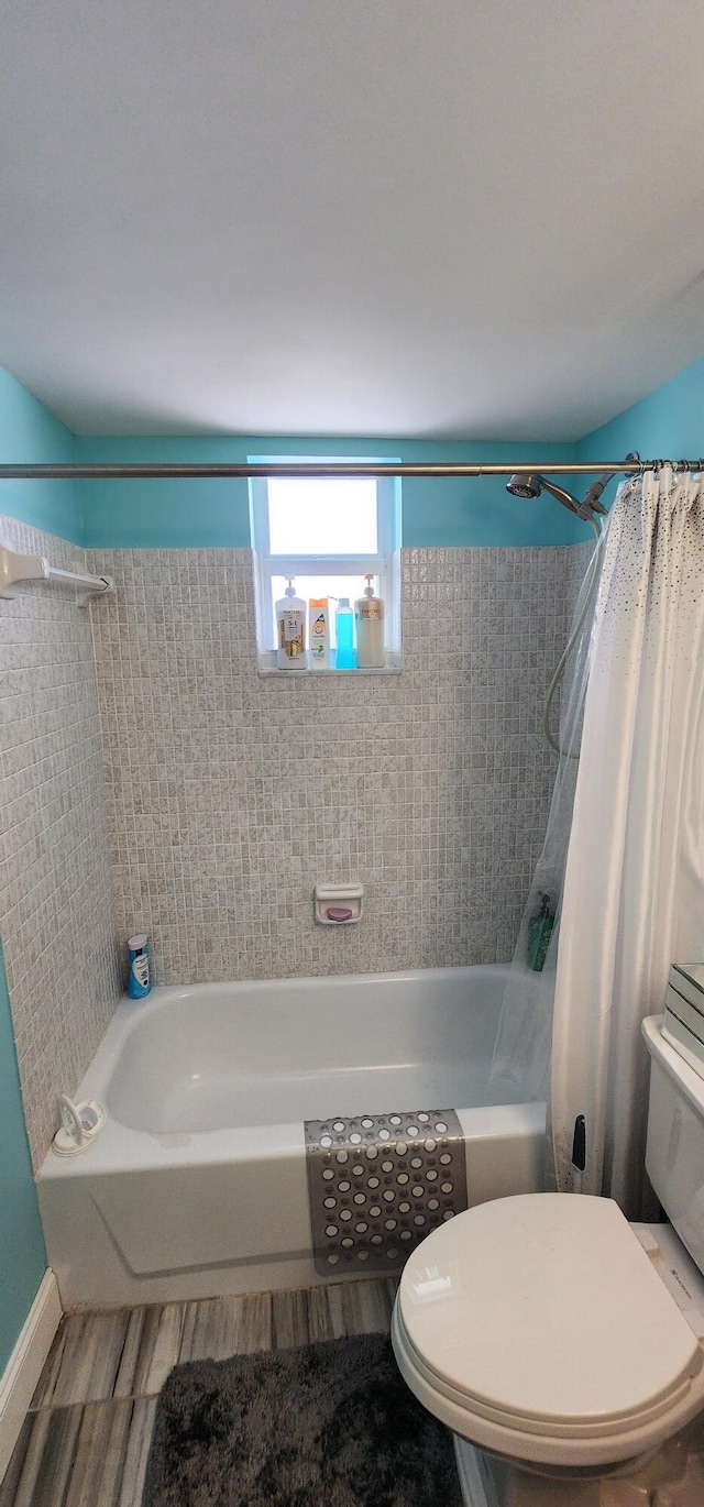 bathroom with toilet and shower / bath combo