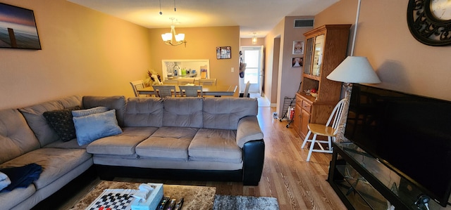 living room with hardwood / wood-style flooring and a chandelier