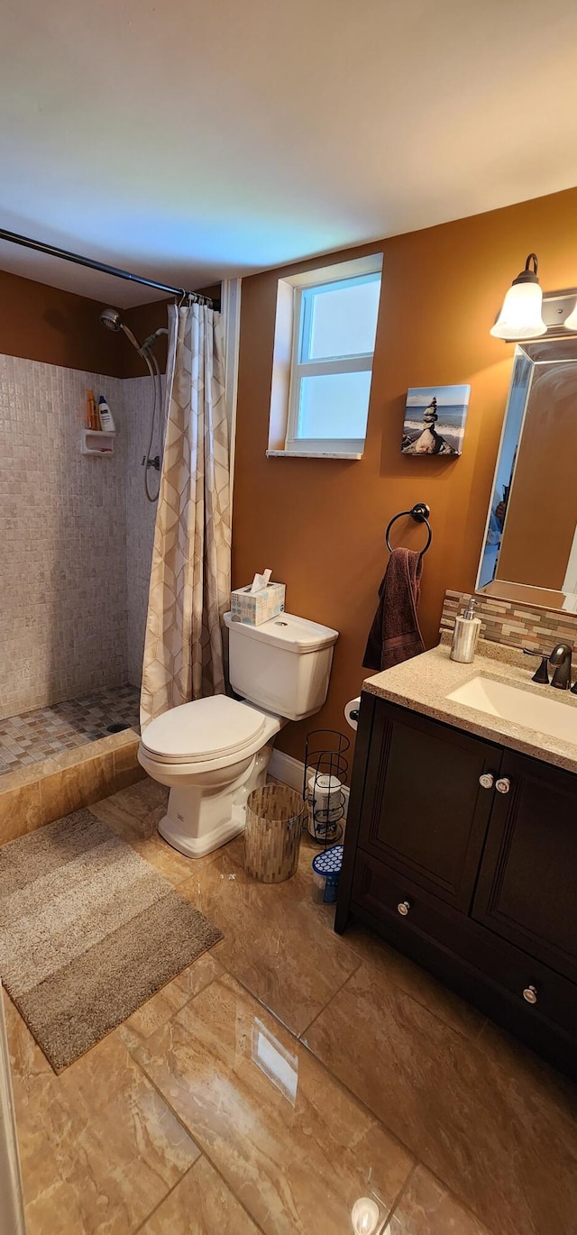 bathroom featuring decorative backsplash, tile patterned floors, vanity, toilet, and a shower with curtain