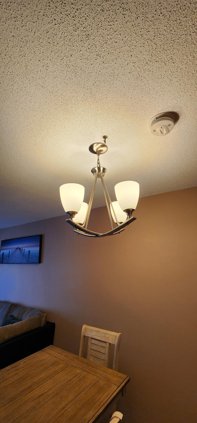 unfurnished dining area with a textured ceiling