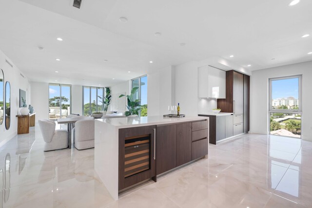 kitchen featuring a center island, wine cooler, and light tile patterned floors