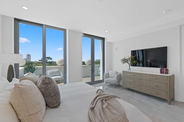 bedroom with recessed lighting, marble finish floor, access to outside, french doors, and floor to ceiling windows