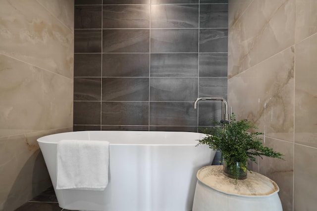 full bathroom featuring a soaking tub and tile walls