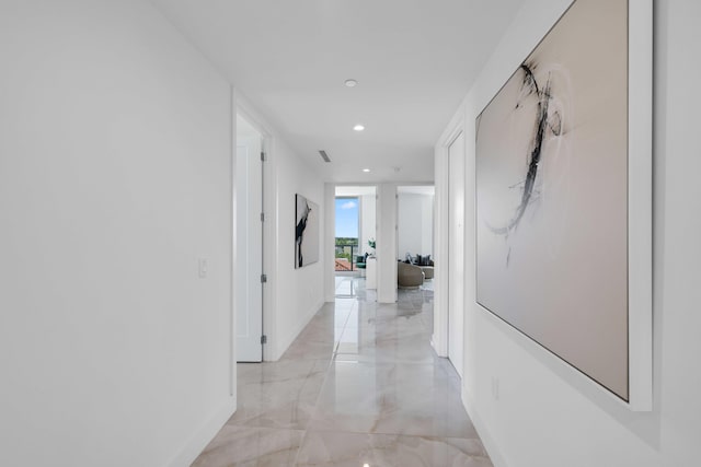 corridor with light tile patterned flooring