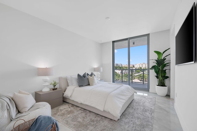 bedroom featuring access to exterior, a wall of windows, and baseboards