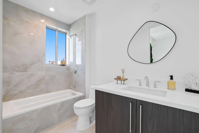 full bathroom featuring tiled shower / bath combo, tile patterned floors, toilet, and vanity