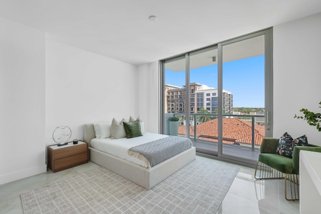 tiled bedroom featuring access to outside and floor to ceiling windows