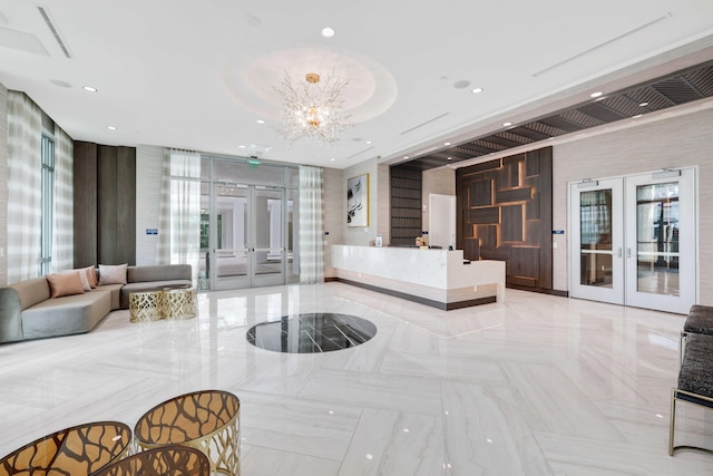 welcome area featuring a chandelier, french doors, and visible vents