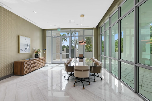 tiled dining area featuring a wall of windows, a healthy amount of sunlight, and french doors