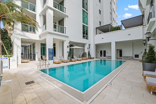 view of swimming pool with a patio