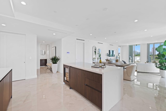 kitchen featuring a spacious island, expansive windows, and light tile patterned floors