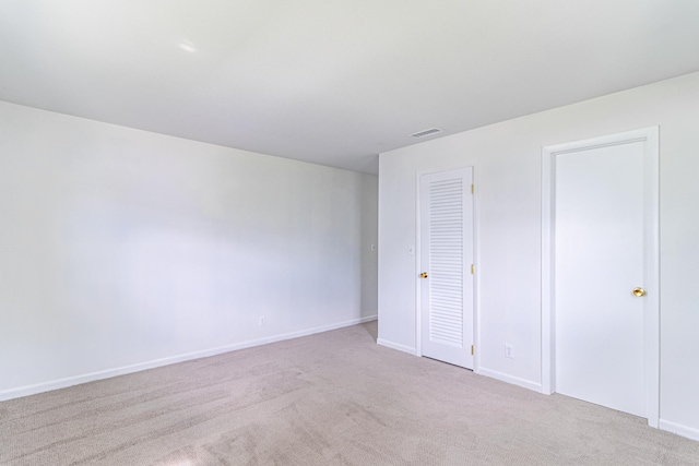 unfurnished bedroom featuring light colored carpet