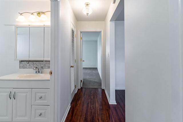 hallway featuring sink and dark hardwood / wood-style flooring