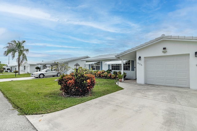 ranch-style home featuring a garage and a front yard