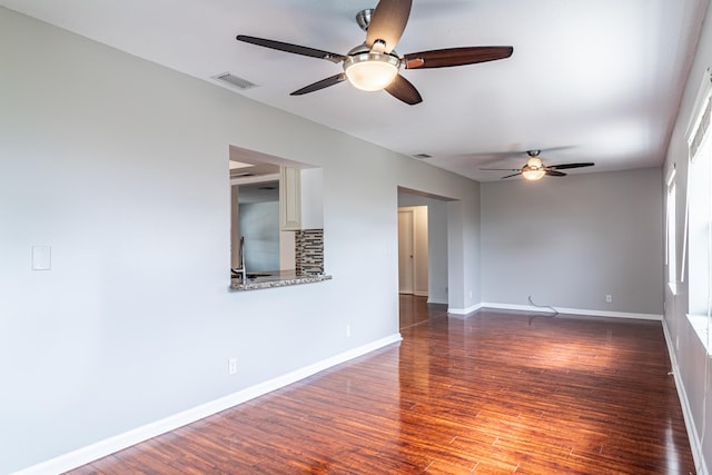 empty room with ceiling fan and hardwood / wood-style flooring