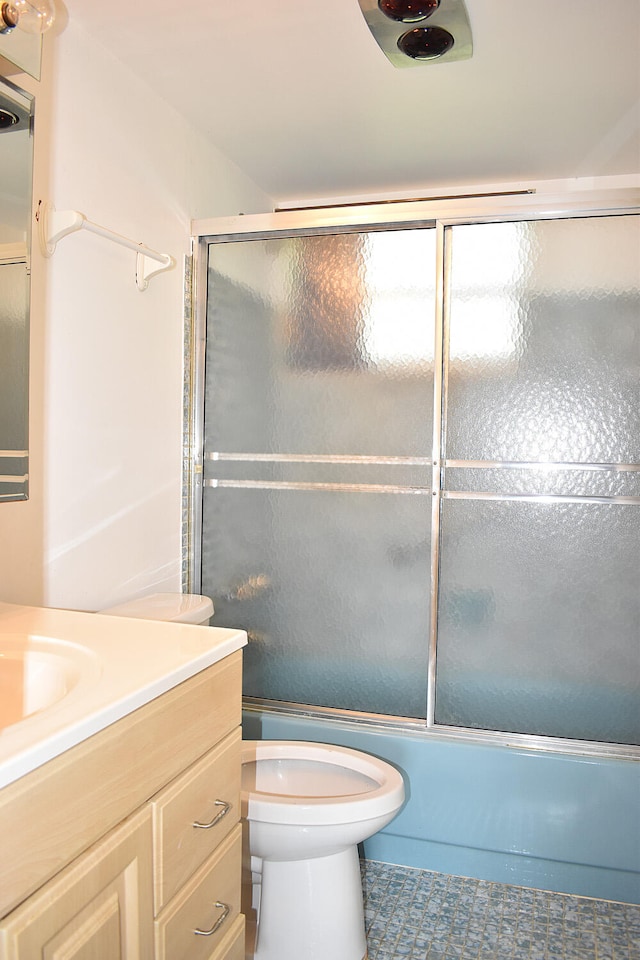 full bathroom featuring tile patterned floors, vanity, shower / bath combination with glass door, and toilet