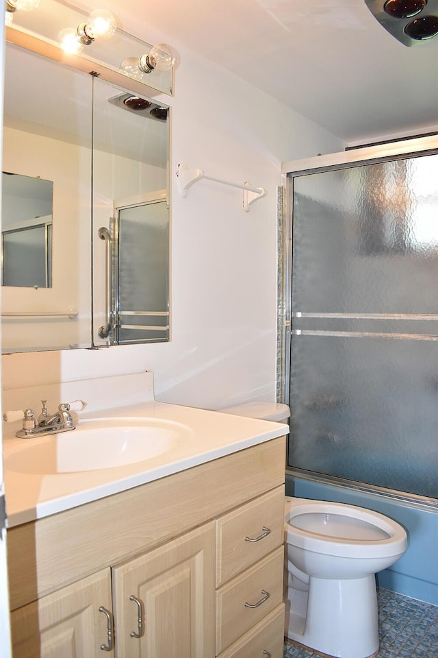 full bathroom featuring toilet, vanity, and shower / bath combination with glass door