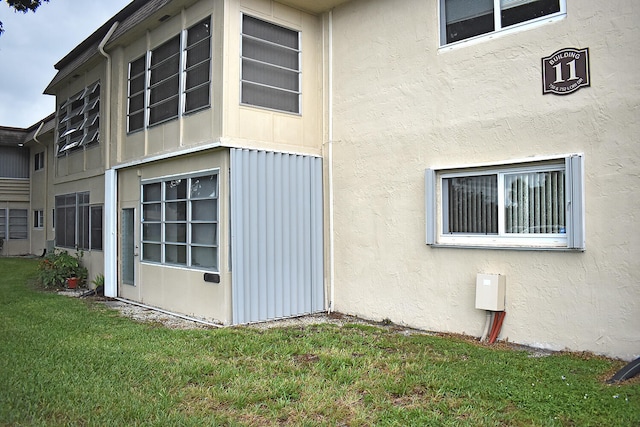 view of property exterior with a yard