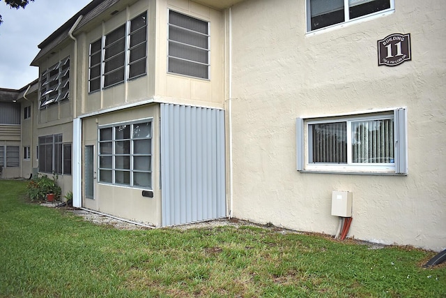 view of property exterior featuring a lawn