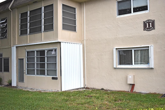 view of side of home featuring a lawn