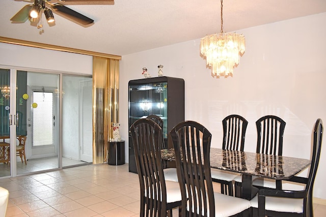 dining space featuring ceiling fan with notable chandelier, a textured ceiling, and light tile patterned floors