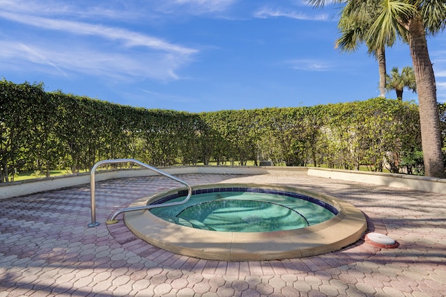 view of pool with an in ground hot tub