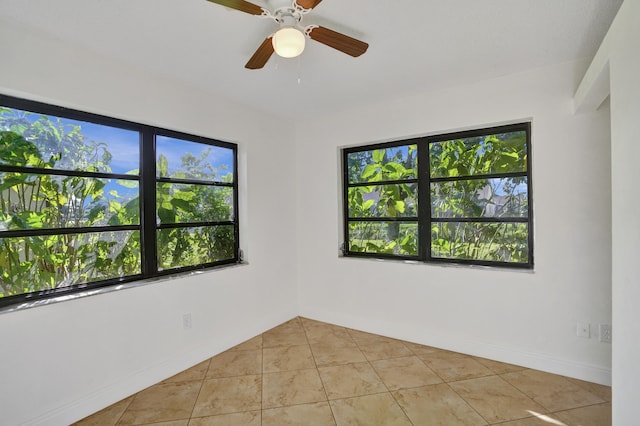 tiled spare room featuring ceiling fan