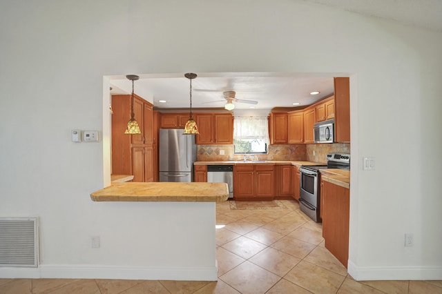 kitchen featuring ceiling fan, sink, decorative light fixtures, light tile patterned flooring, and appliances with stainless steel finishes