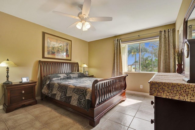 bedroom featuring a ceiling fan, baseboards, and light tile patterned floors