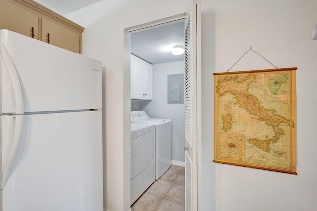 laundry room with electric panel, cabinet space, washing machine and clothes dryer, and light tile patterned flooring