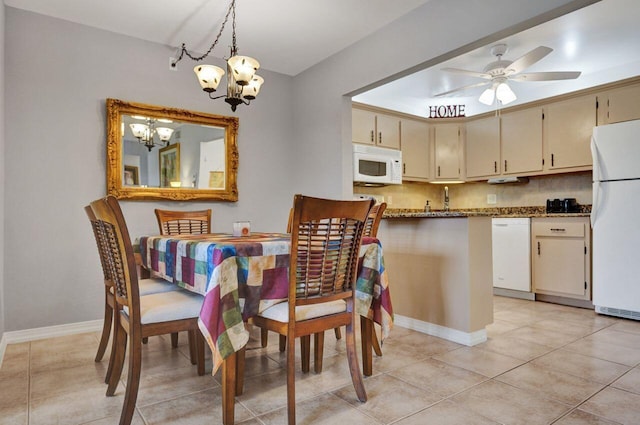 dining space with light tile patterned flooring, baseboards, and ceiling fan with notable chandelier