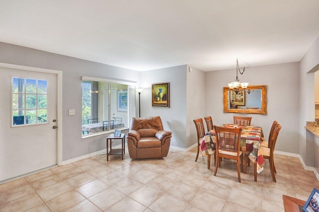 dining room with light tile patterned floors, an inviting chandelier, and baseboards