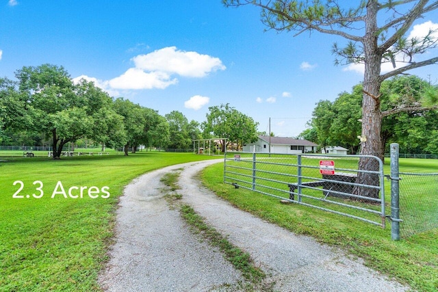 view of street featuring a gate, driveway, and a gated entry