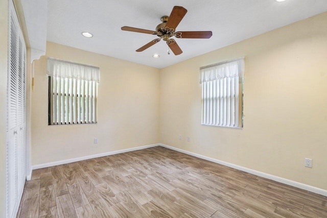 unfurnished room featuring light wood-type flooring and ceiling fan