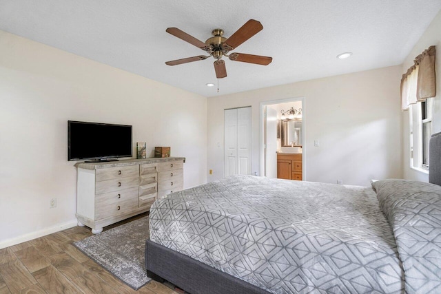17351 77th Ln N, The Acreage, FL 33470 - bedroom with wood finished floors, baseboards, ensuite bathroom, ceiling fan, and recessed lighting