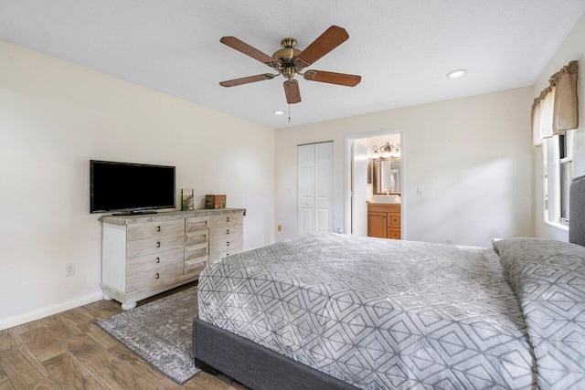 bedroom featuring ceiling fan, a textured ceiling, dark wood-type flooring, a closet, and ensuite bath