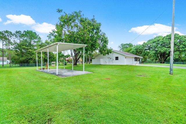 view of yard featuring a detached carport and fence