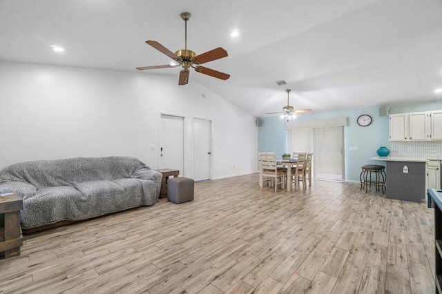 17351 77th Ln N, The Acreage, FL 33470 - living room with a ceiling fan, baseboards, lofted ceiling, and light wood finished floors