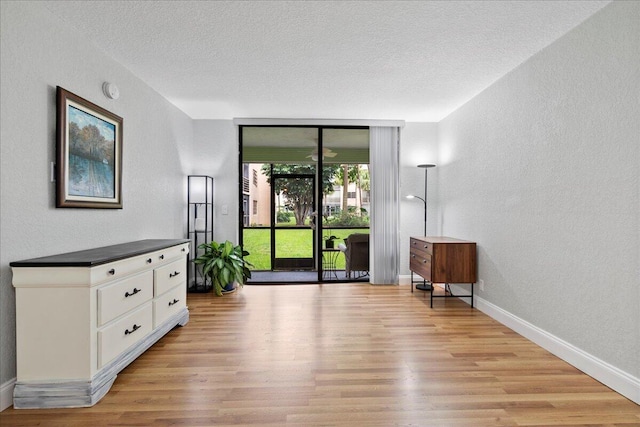 interior space featuring a textured ceiling and light hardwood / wood-style flooring