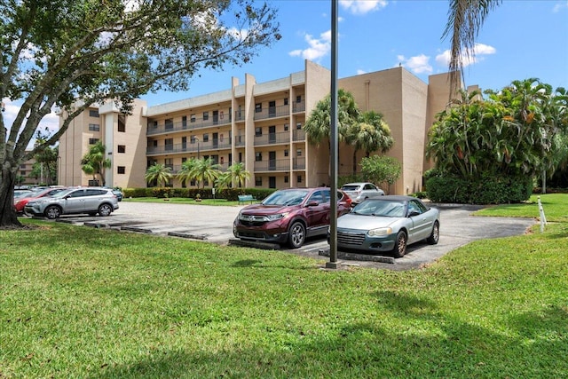 view of building exterior with uncovered parking