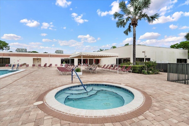 view of pool featuring a patio and a hot tub