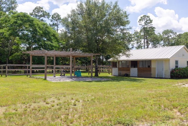 view of yard featuring a pergola and an outdoor structure