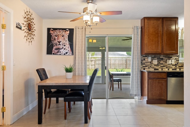 tiled dining space with ceiling fan and a textured ceiling