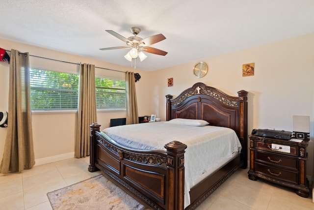 tiled bedroom featuring ceiling fan and a textured ceiling