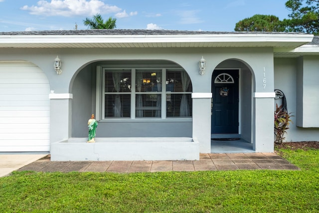 property entrance with a lawn and a porch