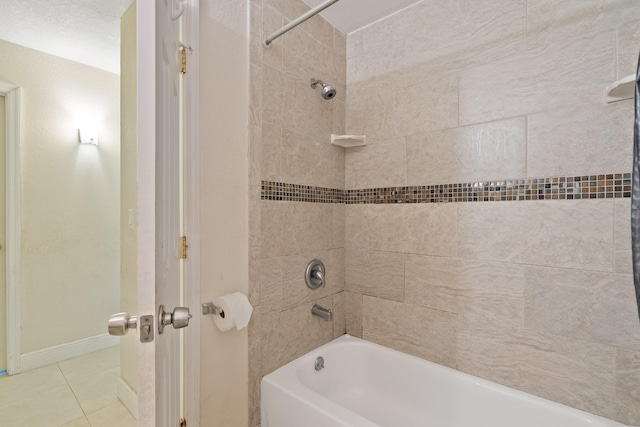 bathroom featuring tile patterned flooring and tiled shower / bath