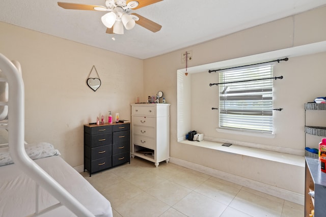 bedroom featuring ceiling fan and tile patterned flooring