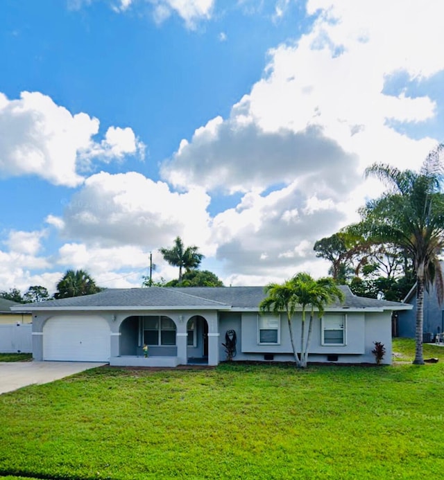 ranch-style house with a garage and a front lawn